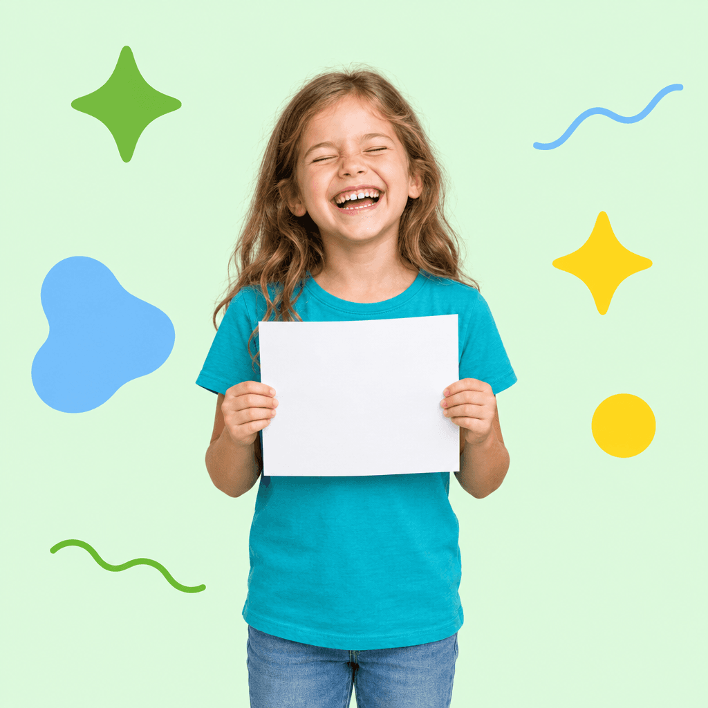 A laughing child holding up a sheet of paper